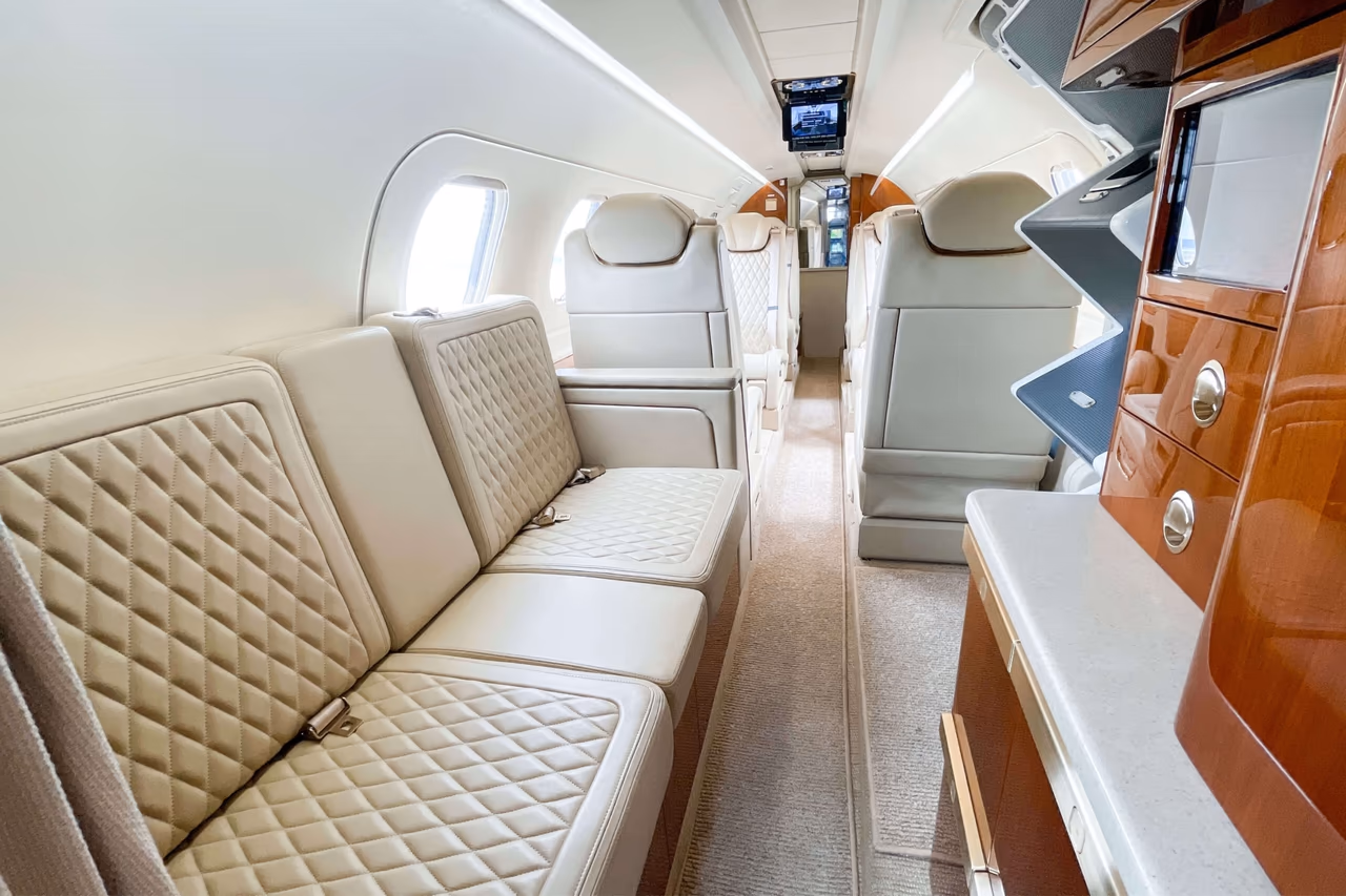 Phenom 300E cabin interior with cream leather club seats